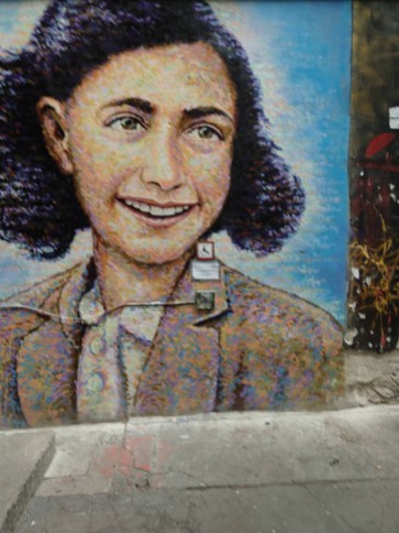 A portrait of Anne Frank on one of the walls